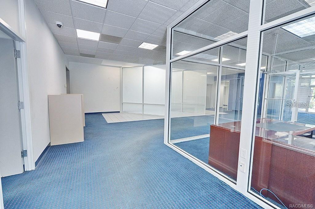 Open customer area with glass-partitioned office space. Open customer area with glass-partitioned office space.