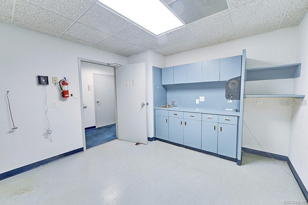 Break room with cabinetry, counter space, and sink.