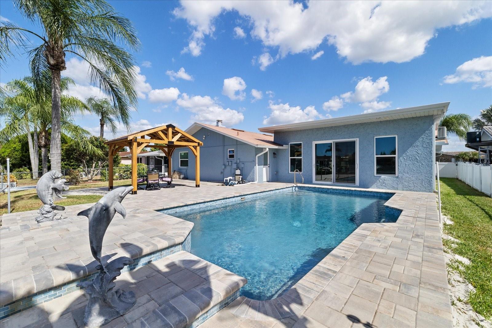 Dolphin statues on waterfall feature pool