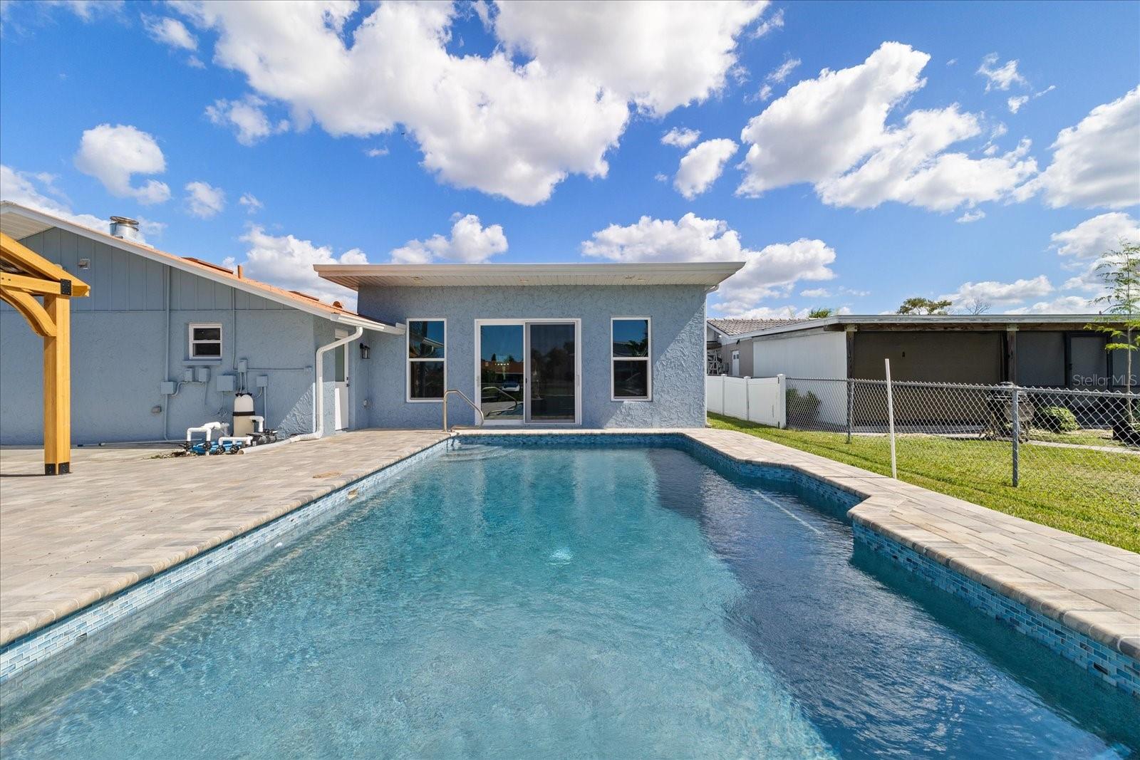 Large sliders to pool and waterfront backyard