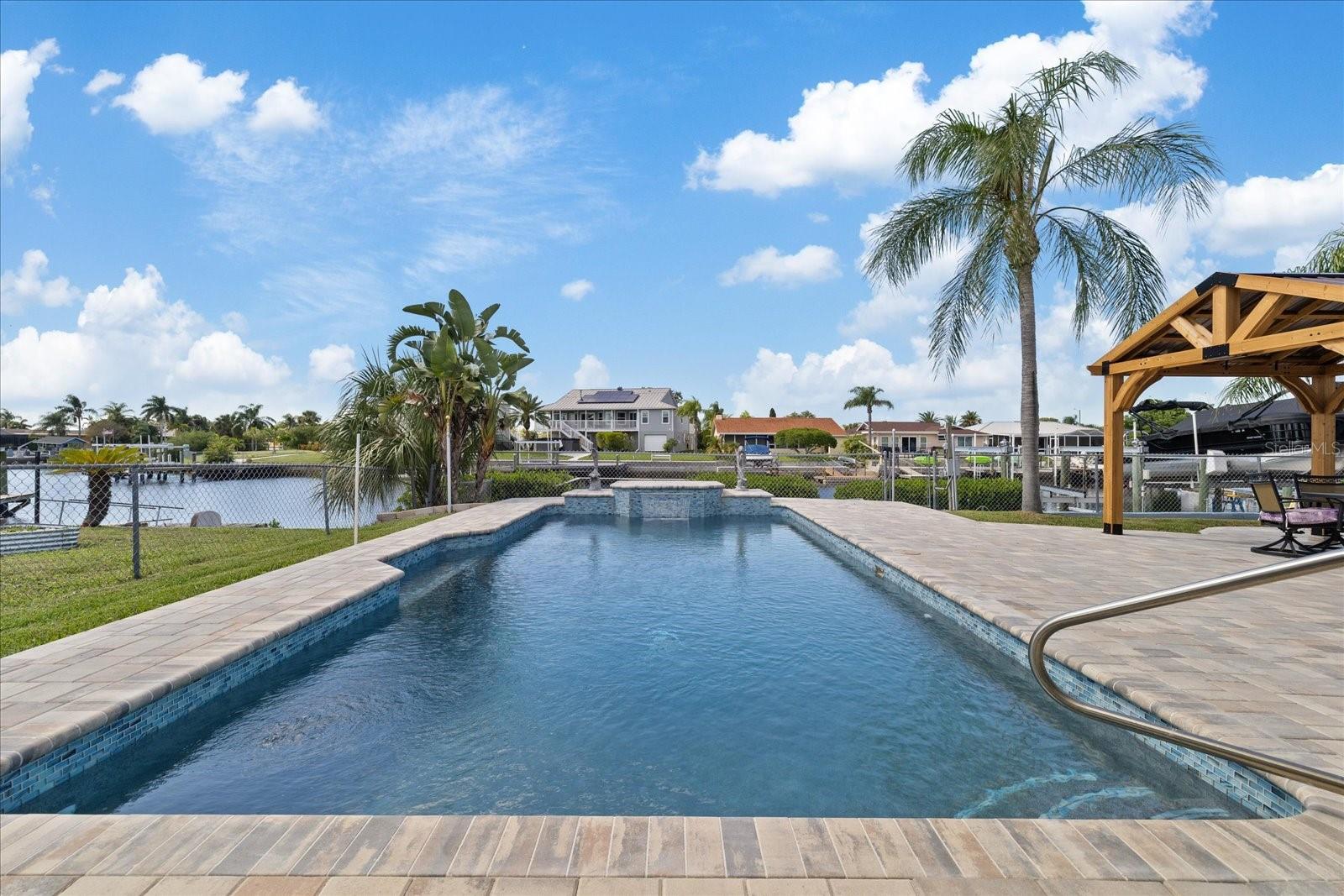 View to the water of pool and waterfall feature