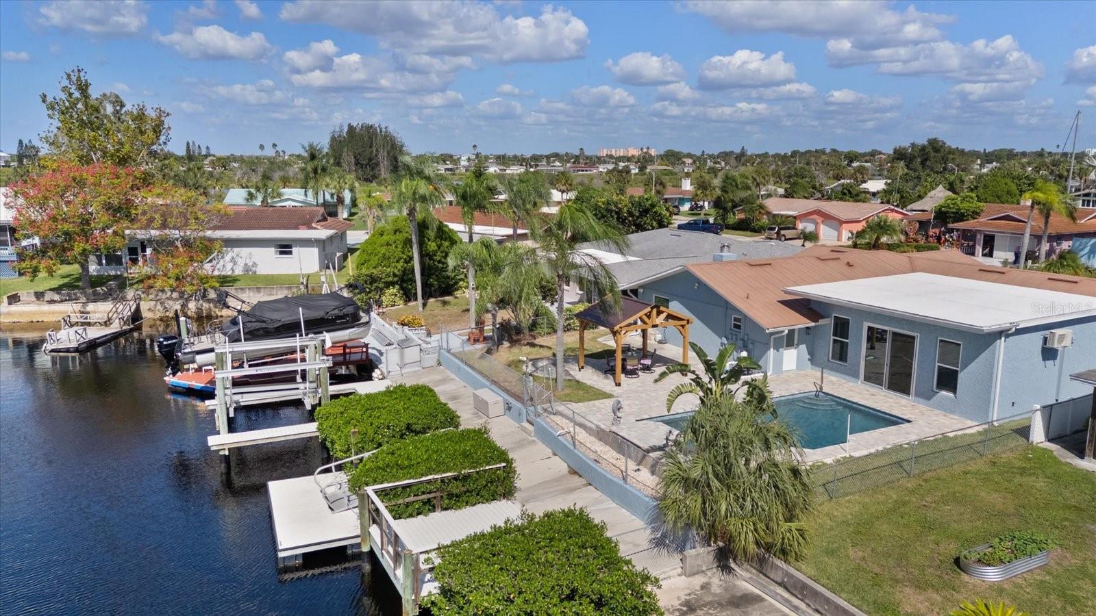 view looking north along docks, boat lift and mangroves