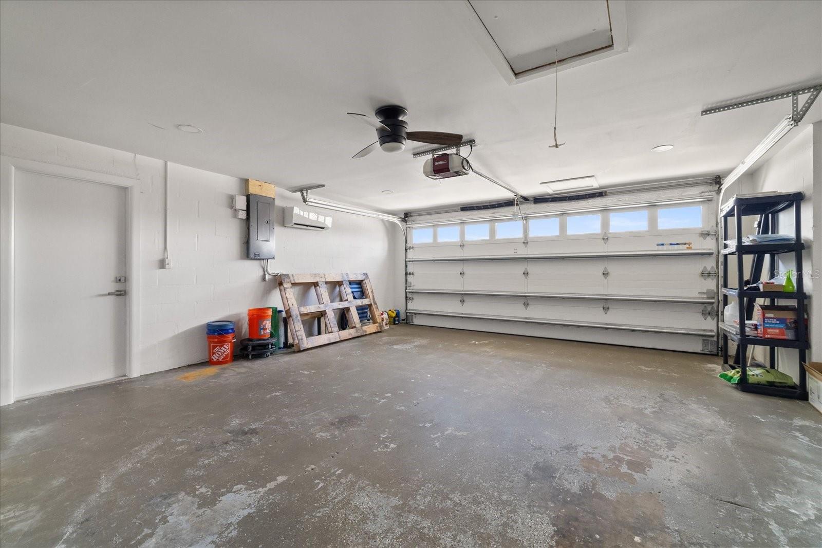 Large garage with hurricane rated door and mini split.