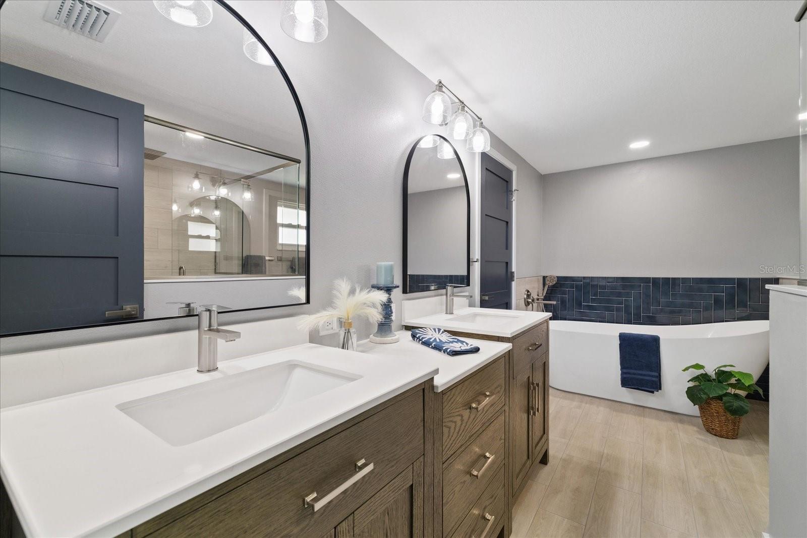 Primary ensuite with double vanity sinks and soaking tub Primary ensuite with double vanity sinks and soaking tub
