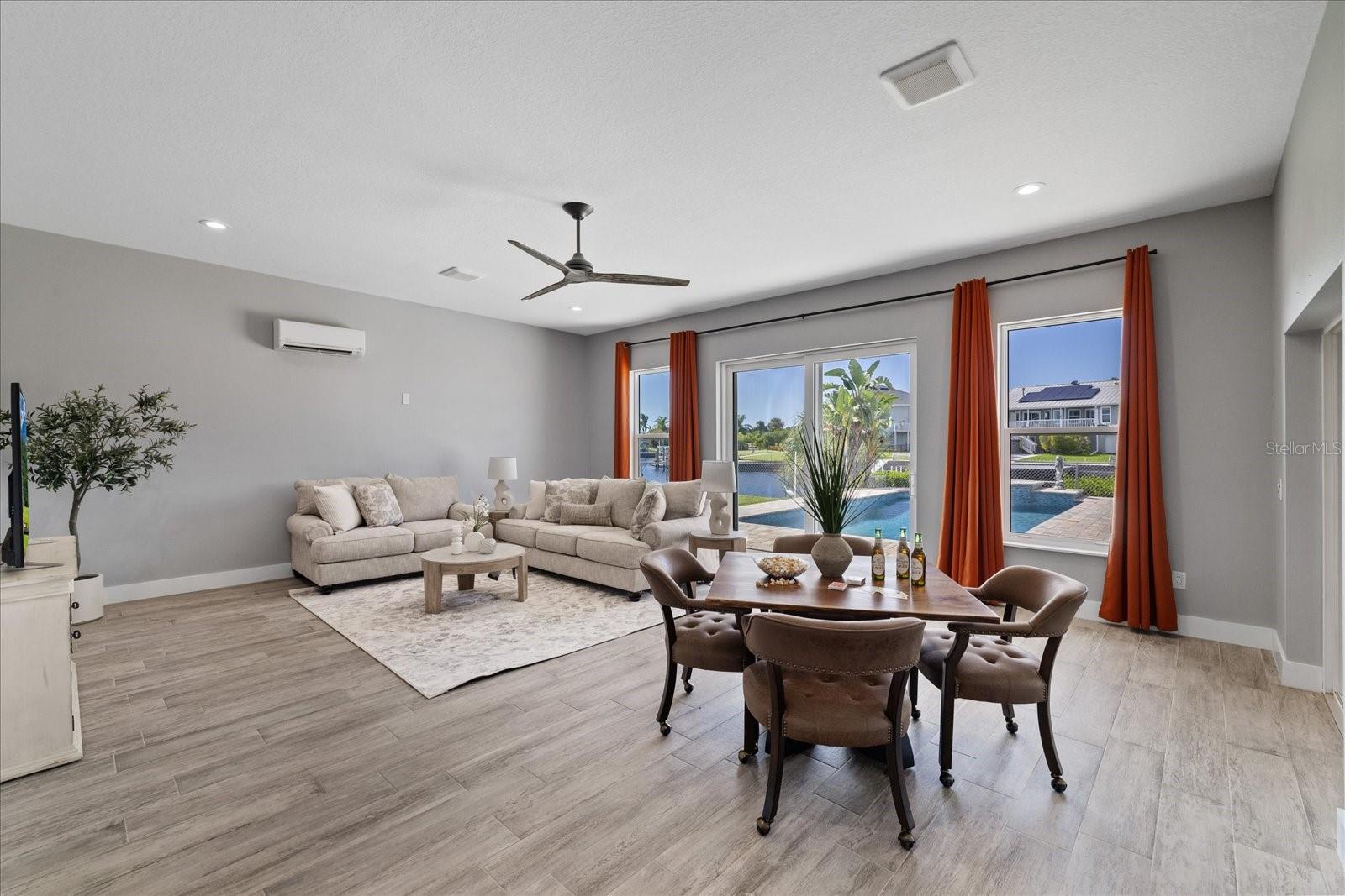Large family room with water and pool views Large family room with water and pool views