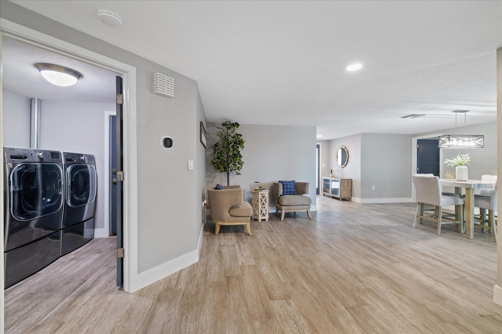 Laundry room centrally located and climate controlled with garage access door.