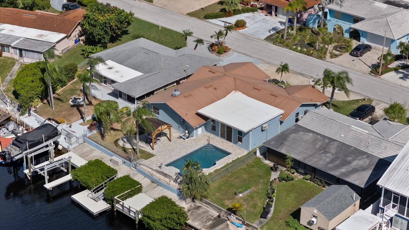 Aerial of home showing waterfall pool, gazebo, boat lift, floating dock and stationary dock Aerial of home showing waterfall pool, gazebo, boat lift, floating dock and stationary dock