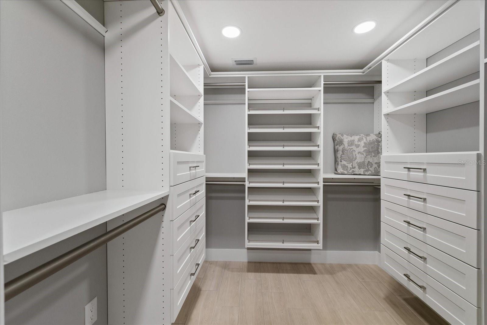 Walk in custom closet in primary full view