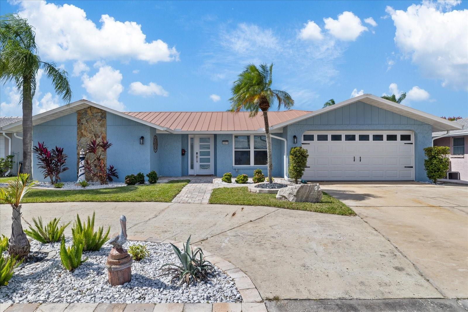 Large driveway, landscaping and garage