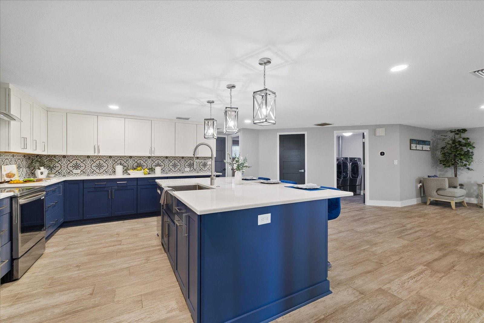 Large island sink in kitchen with breakfast bar Large island sink in kitchen with breakfast bar