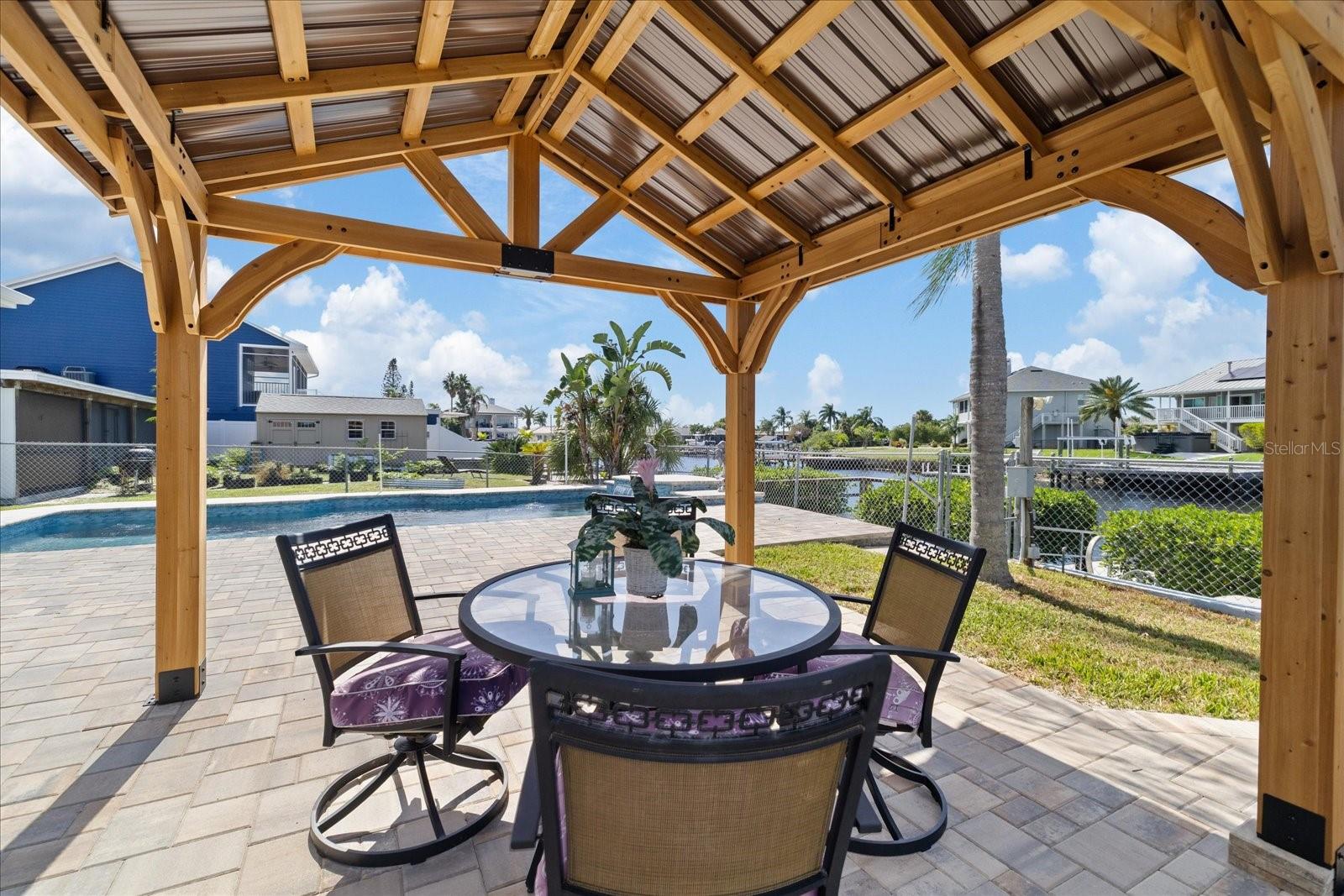 Gazebo shaded area on pavered pool deck