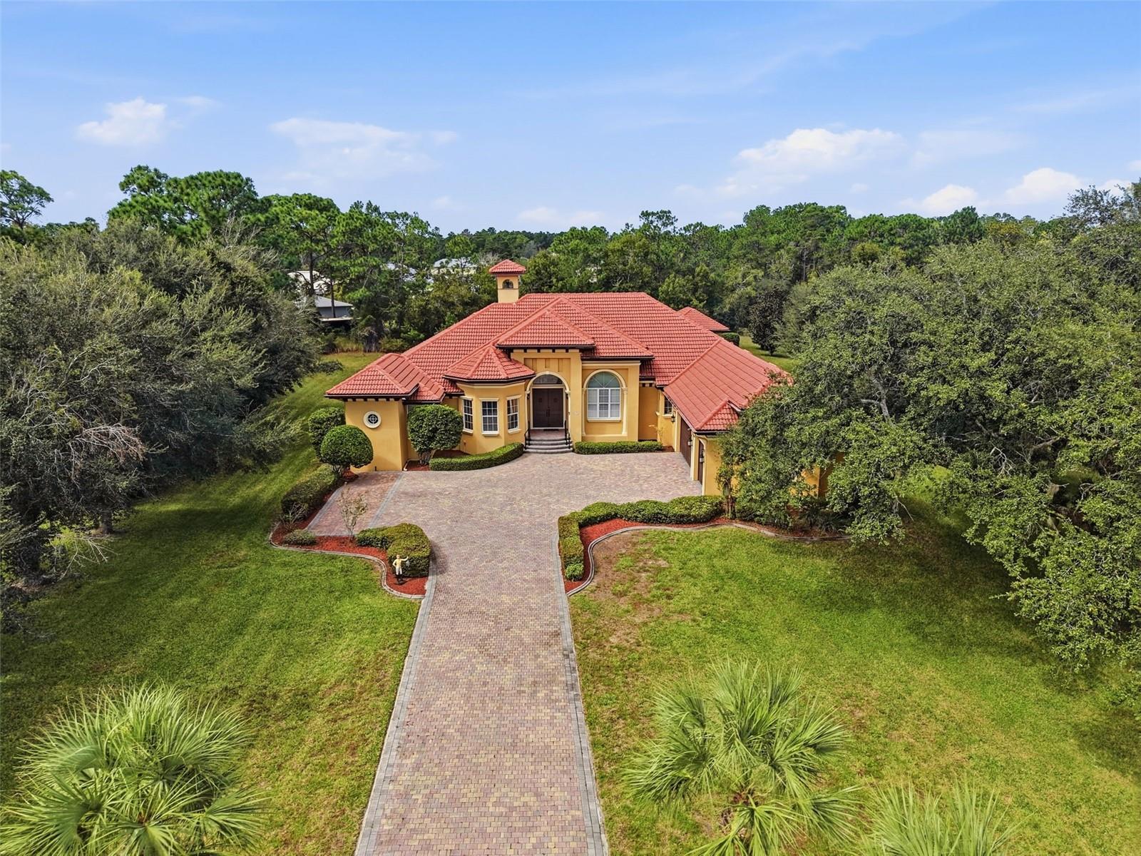 Gorgeous tile roof and long private paver driveway with gated entrance!