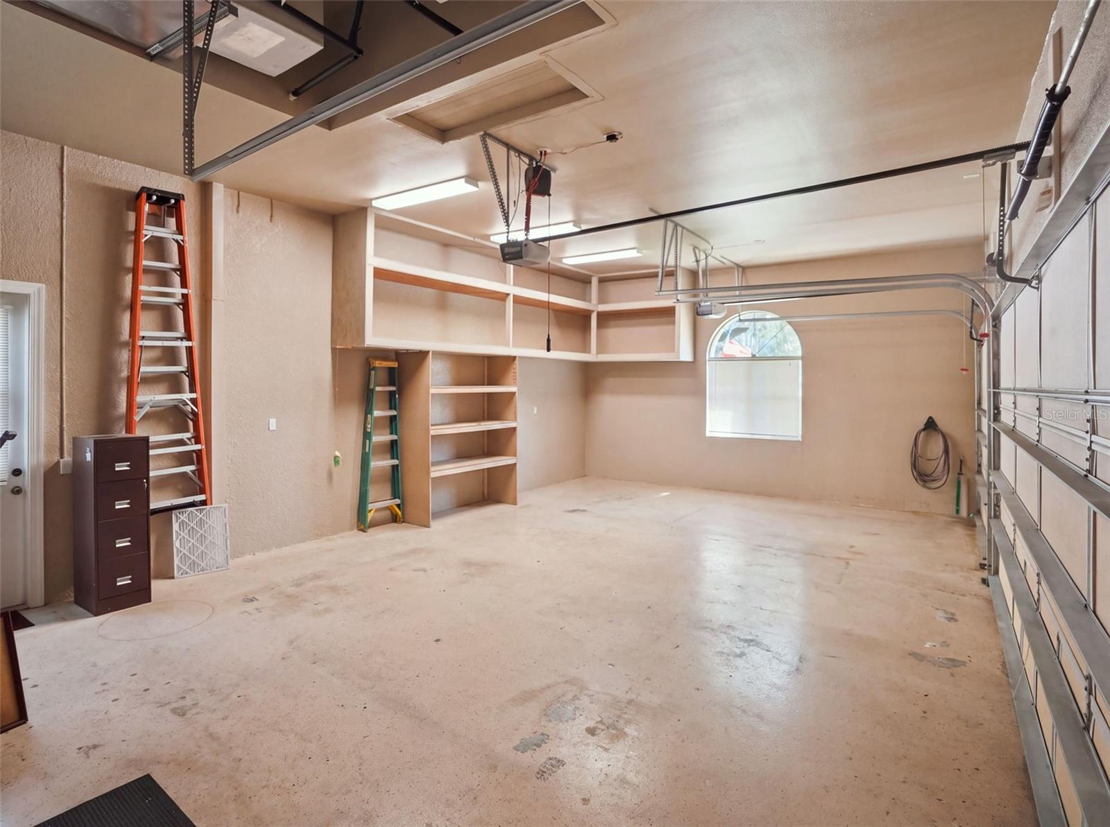 Large and deep 3-car garage with extra tall doors for large trucks/vehicles.