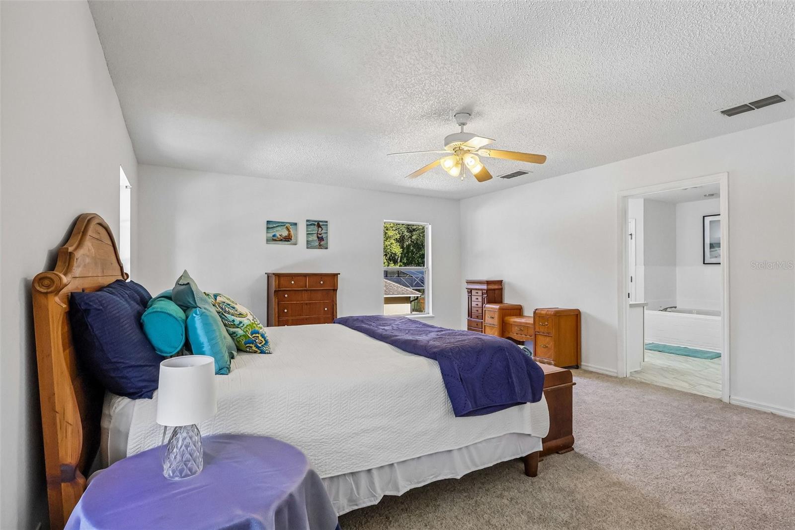 Large master bedroom with en-suite bath and two walk-in closets.