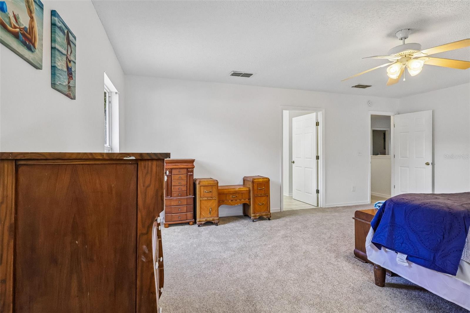 Large master bedroom with en-suite bath and two walk-in closets.