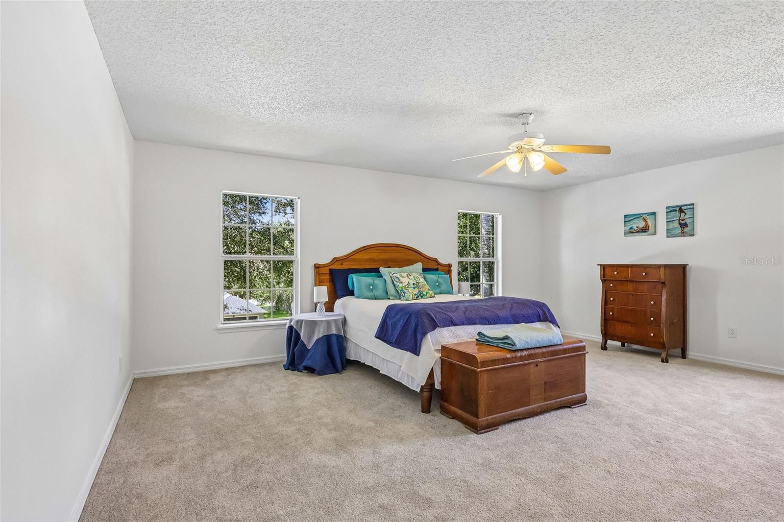Large master bedroom with en-suite bath and two walk-in closets.