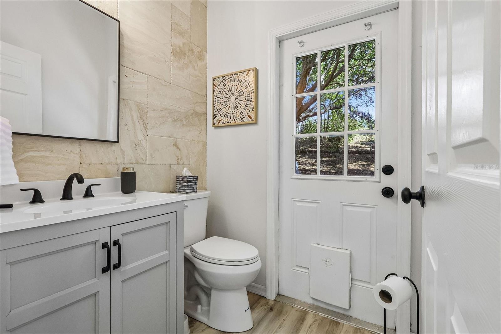 Powder room facing the backyard. Great for outdoor play then clean up here before dinner.