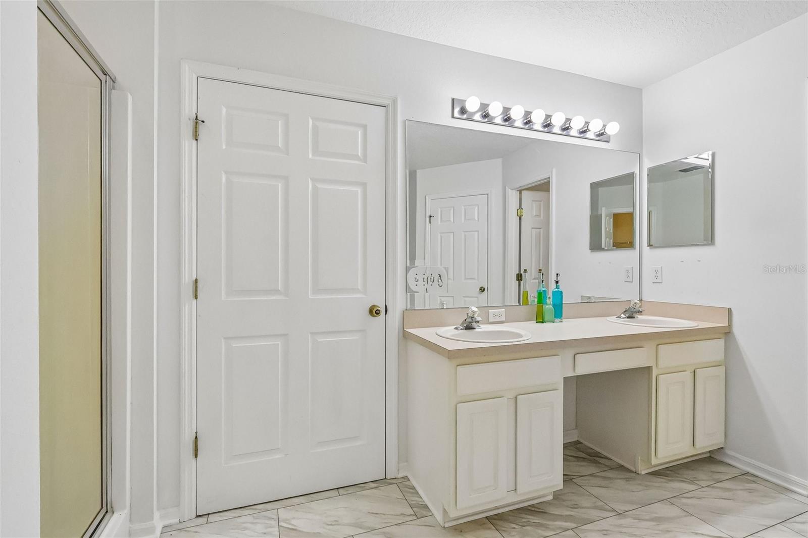 Master bath with water closet, stand up shower, soaking tub, and two walk-in closets.