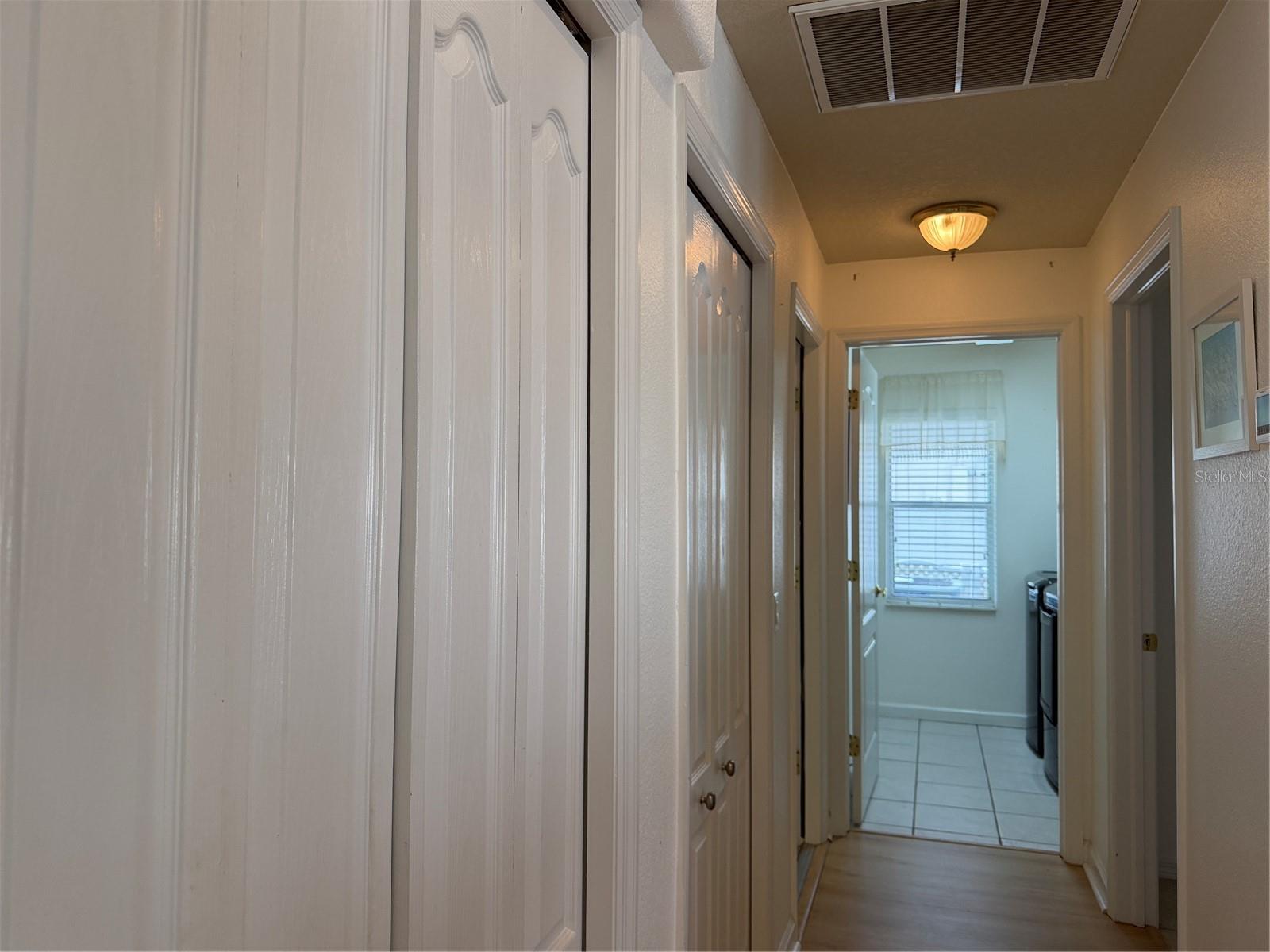 Beyond closets to the left is a door that enters bonus room and garage. Straight ahead is indoor laundry room. Door to right leads to 2nd bedroom