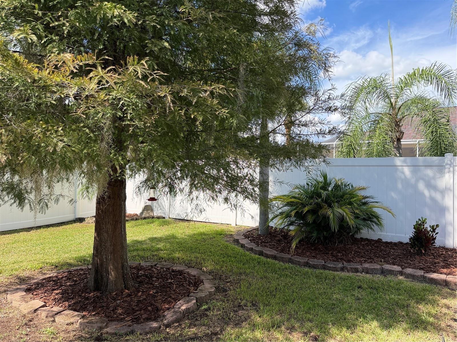 A privacy fence wraps around back yard