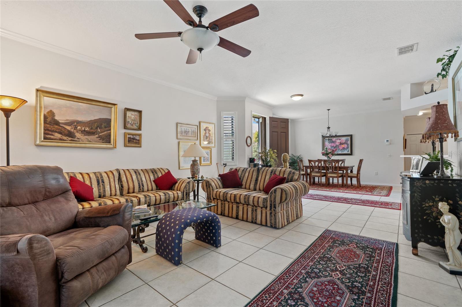 LIVING ROOM WITH VIEW TO DINING ROOM AND FRONT DOOR.