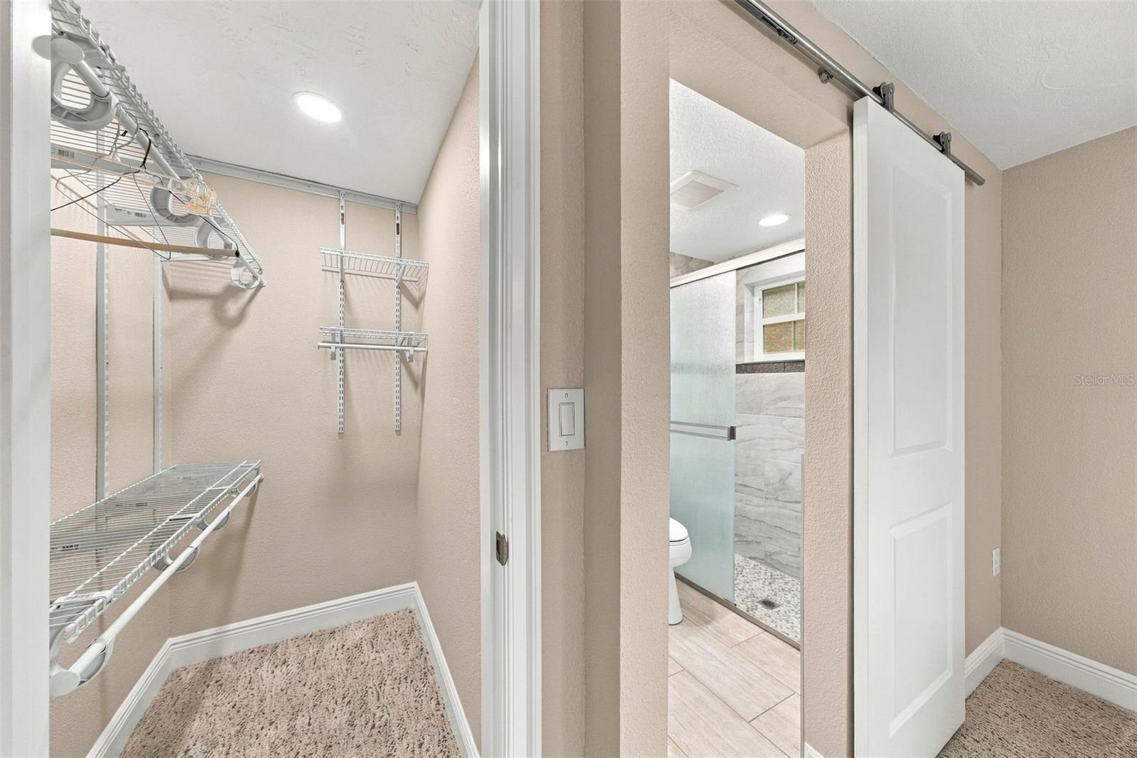 Primary bedroom walk in closet