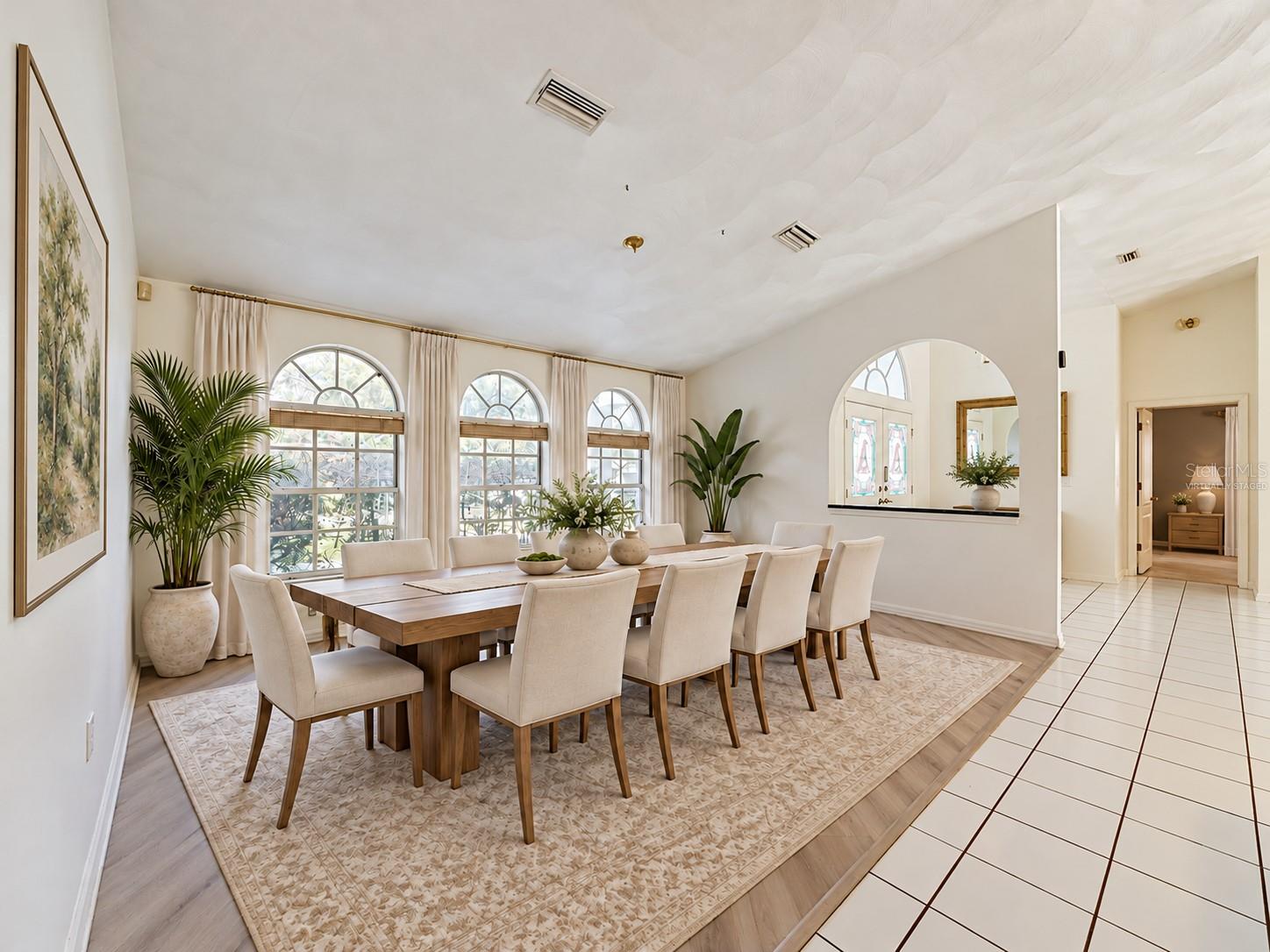 Large virtually staged dining room is versatile as a traditional room or . . .