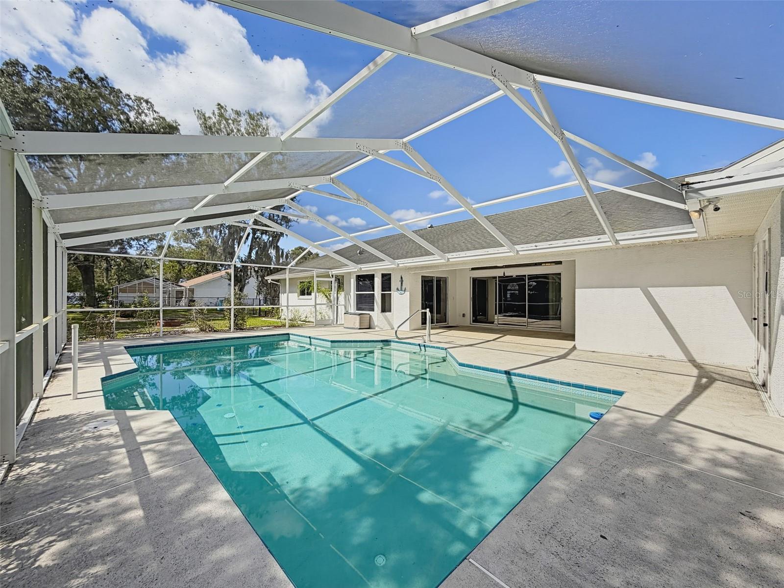 Heated saltwater swimming pool with bath, outdoor shower, and storage.