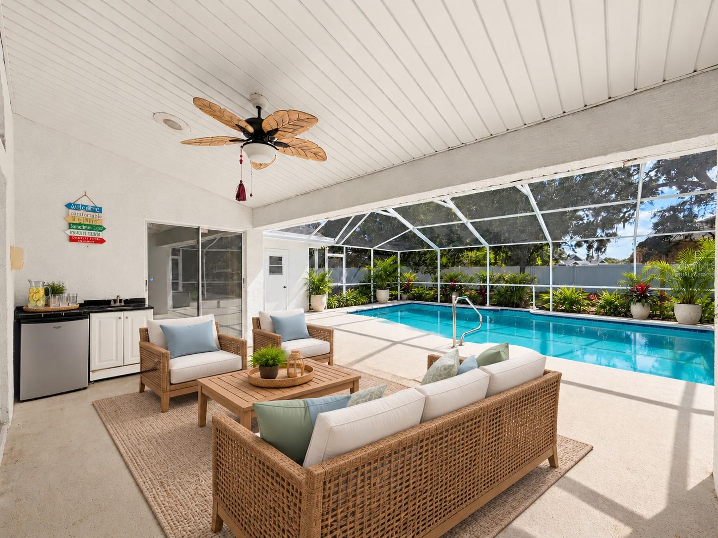 Large covered patio with minifridge and sink. (virtually staged)