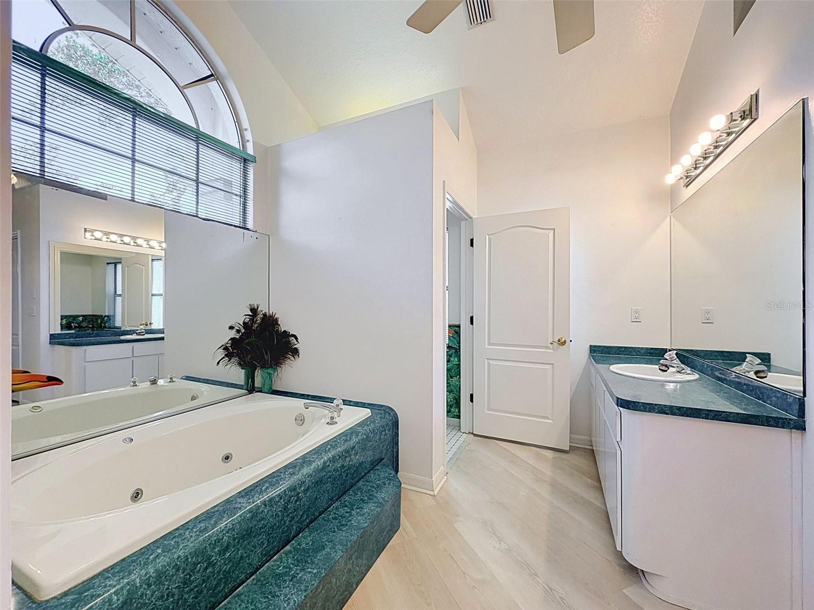 Owner's suite includes jetted tub, two WICs, linen closet, water closet, two vanities, and large shower.