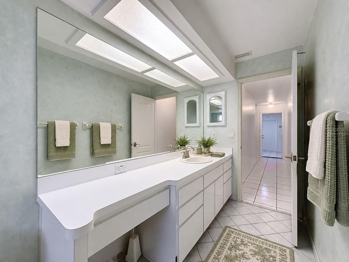 Hall bathroom is large with lots of storage. (virtually staged)