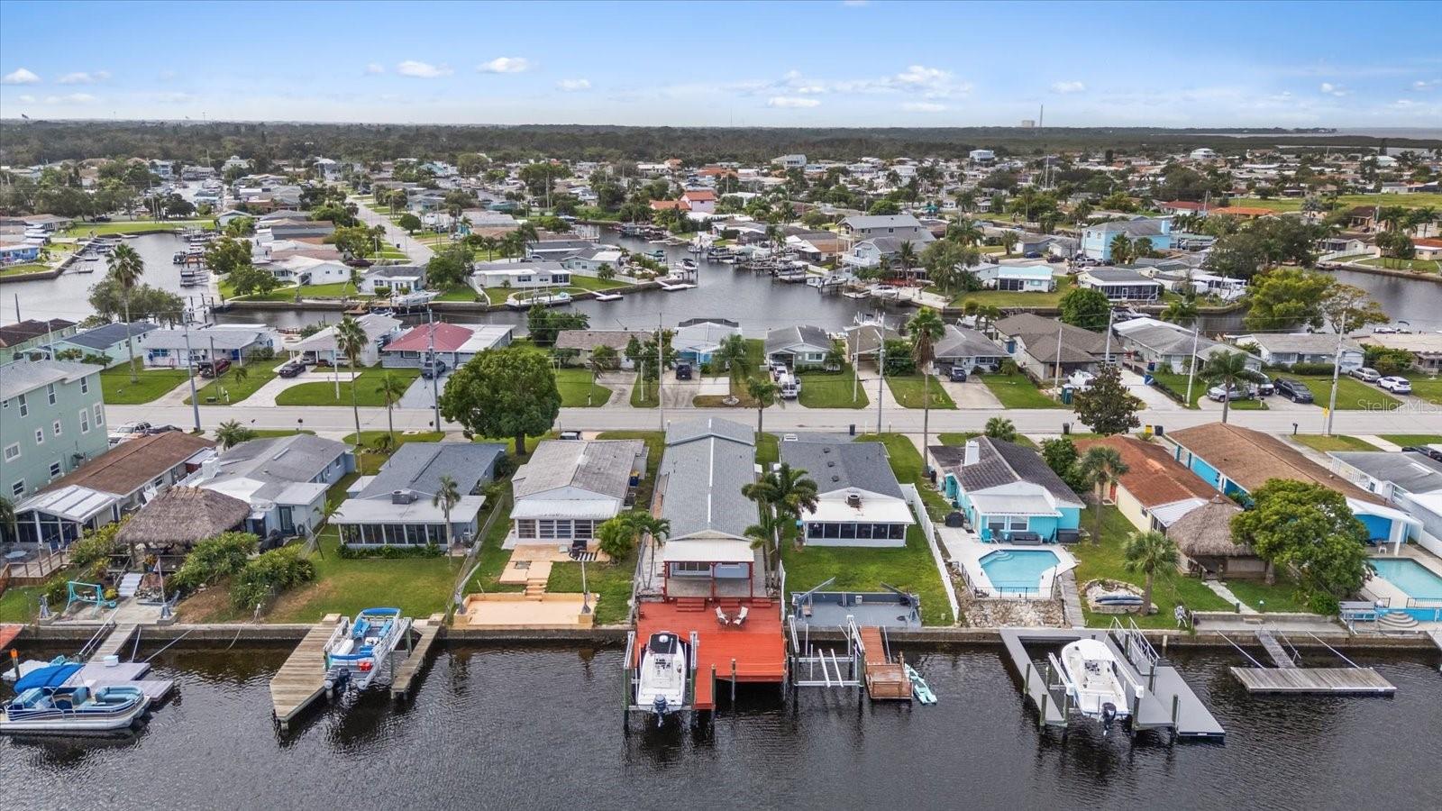Aerial view of home with red deck/boat lift looking south.