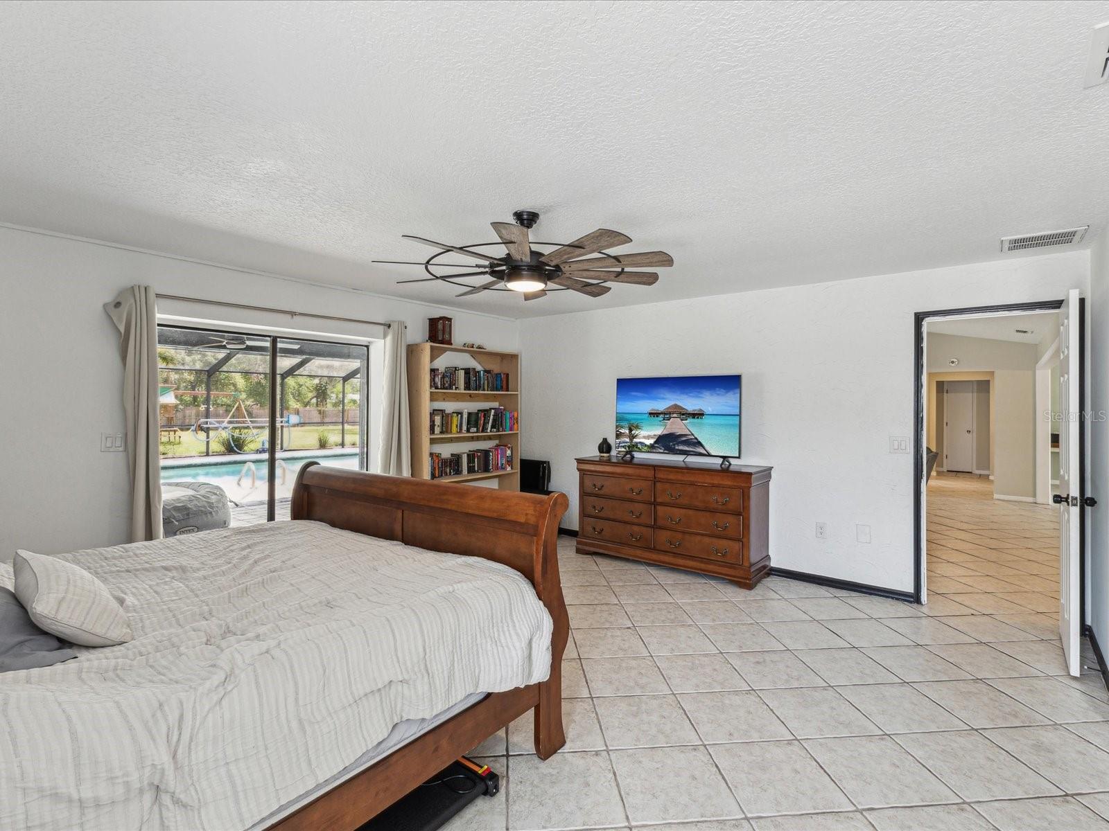 Primary Bedroom with Sliders to Patio and Pool