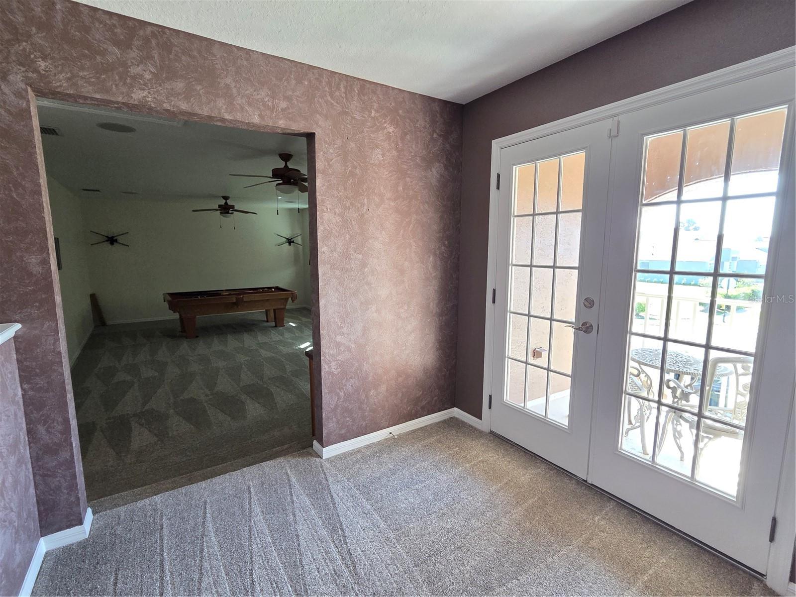 Area upstairs outside bonus room and double doors to outside balcony