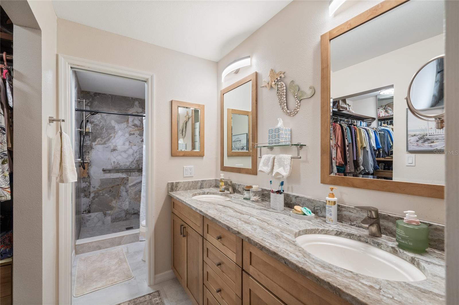 PRIMARY BATHROOM WITH WALK-IN SHOWER, DOUBLE SINKS AND MIRROWS AND GRANITE COUNTERTOPS.  SEPARATE TOILET ROOM WITH POCKET DOOR.  LARGE WALK-IN CLOSET.