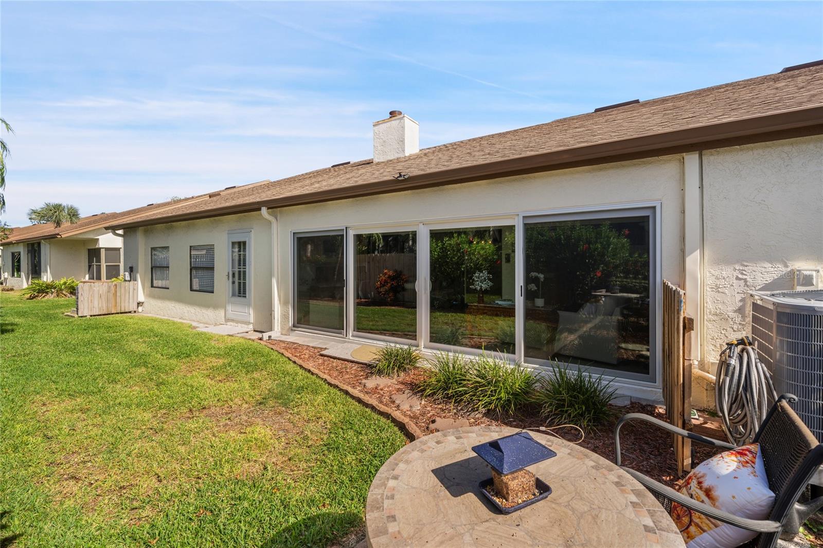 REAR OF HOUSE SHOWING LARGE ENCLOSED LANAI