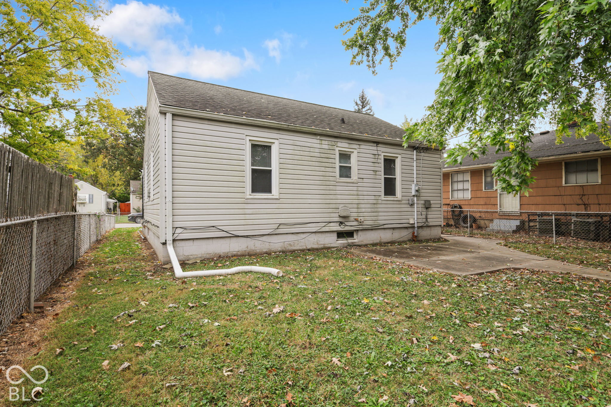 Exterior siding, concrete patio, and fenced-in backyard area