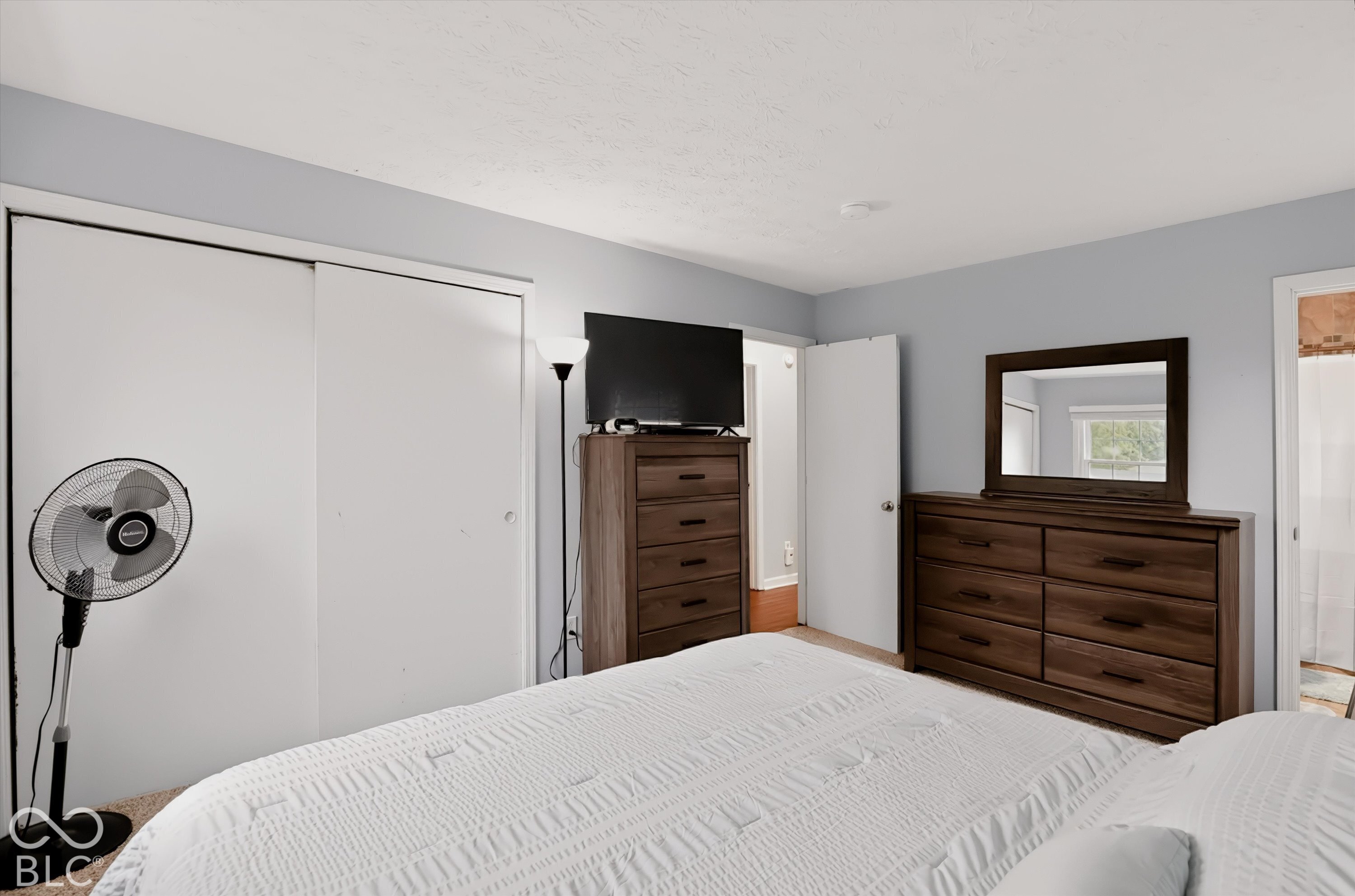 Neutral-toned walls and dual sliding-door closet