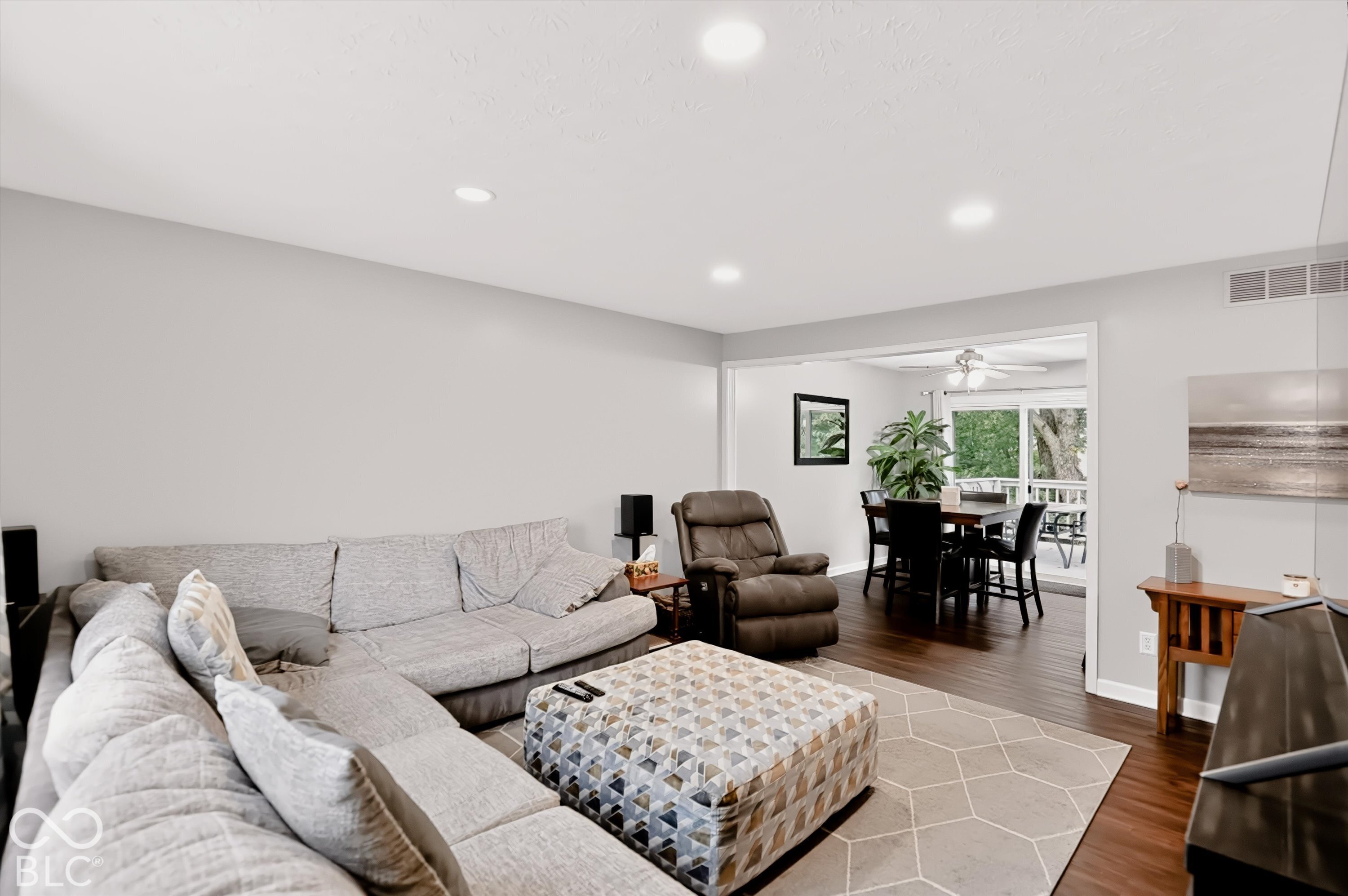 Neutral interior space featuring recessed lighting, wood-finish flooring, and sliding glass doors