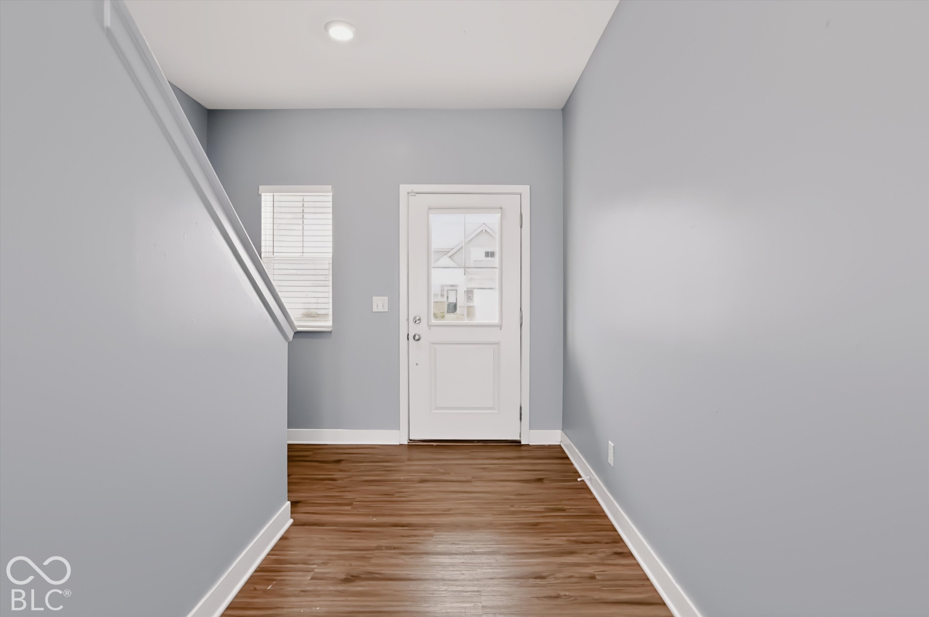 Entryway featuring wood-finish flooring, a glass-panel exterior door, and recessed lighting
