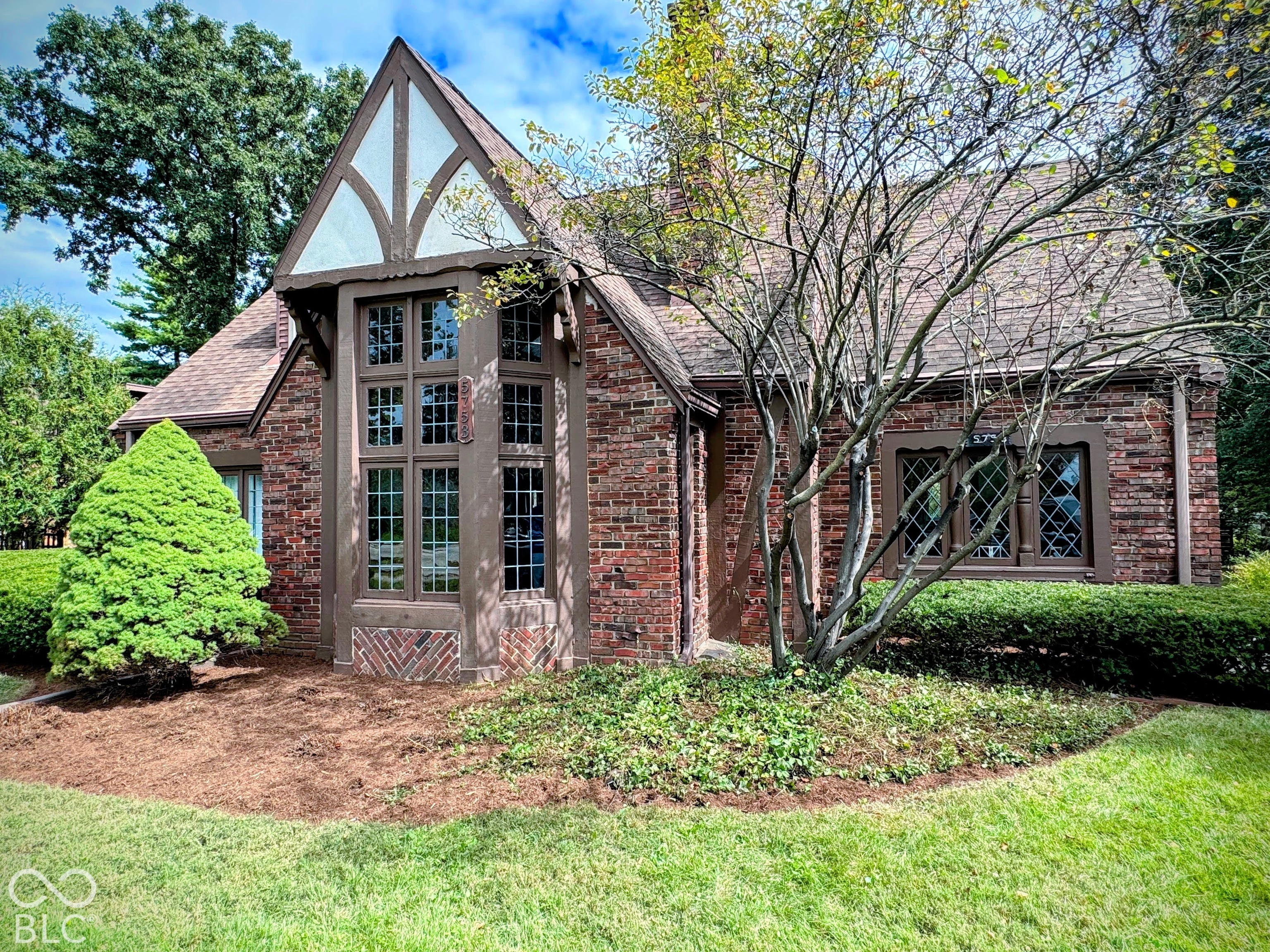 Brick exterior featuring a gabled roofline