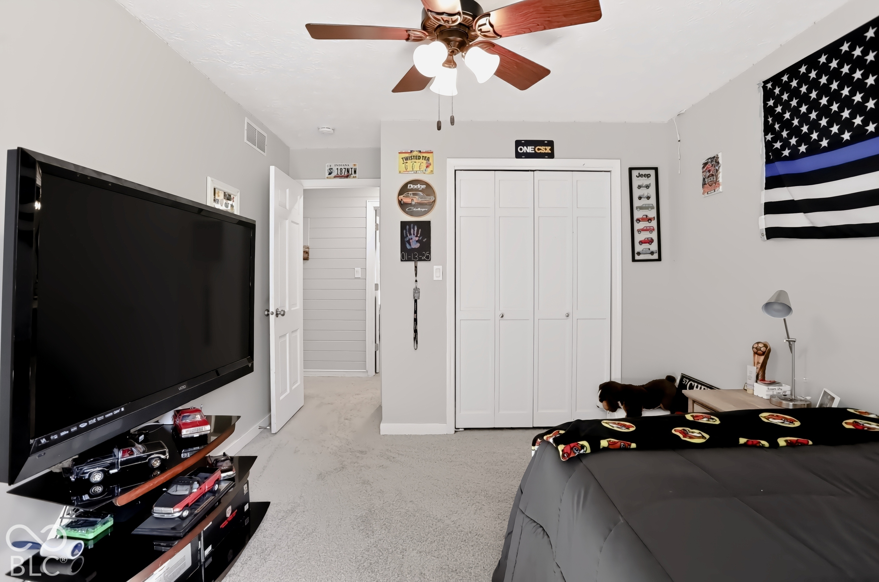 Recessed lighting, wood-finish ceiling fan, neutral wall color, carpeted flooring, and a bi-fold closet door