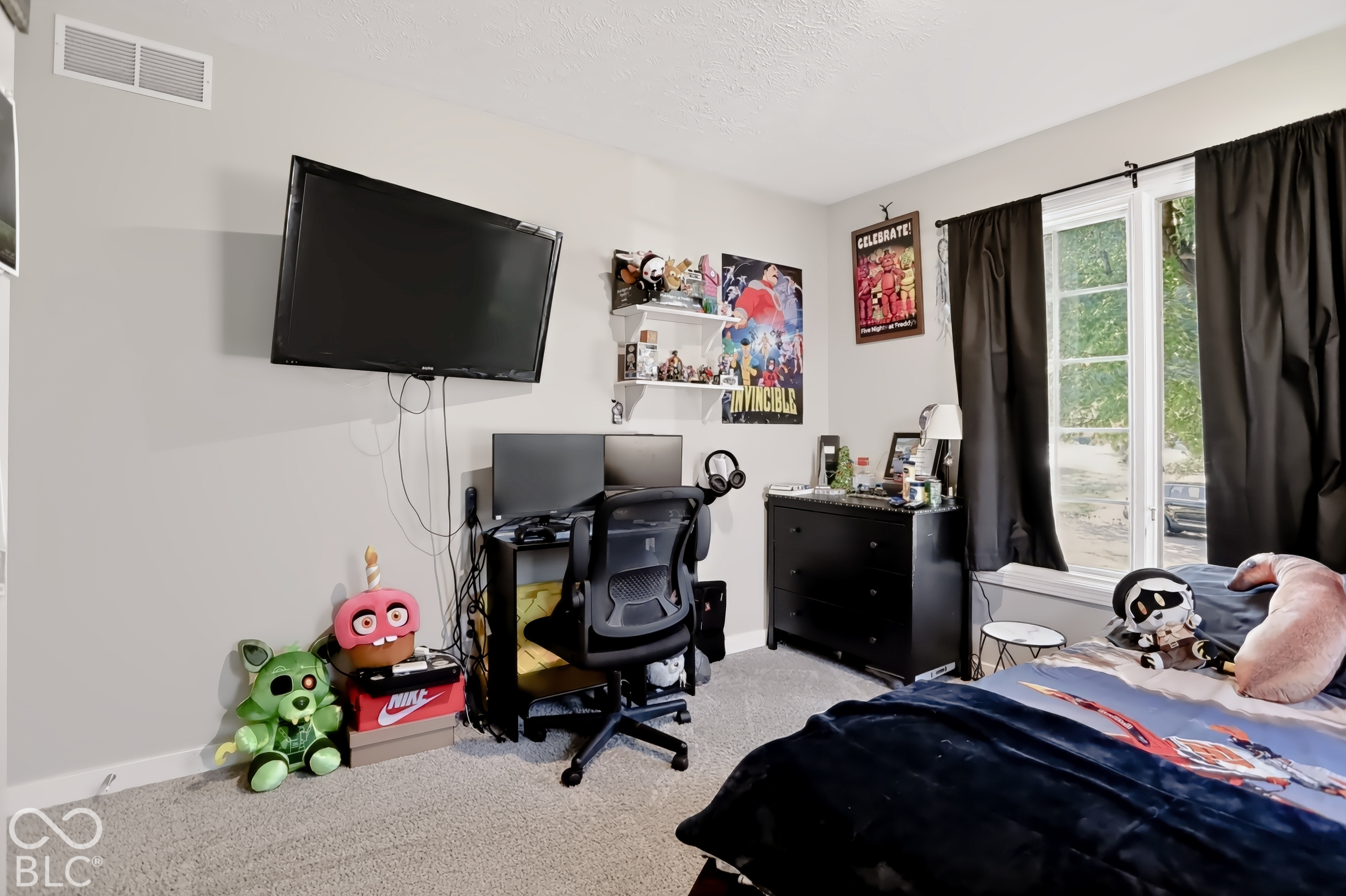 Hardwood-finish flooring, large window with natural light, wall-mounted display, and built-in shelving