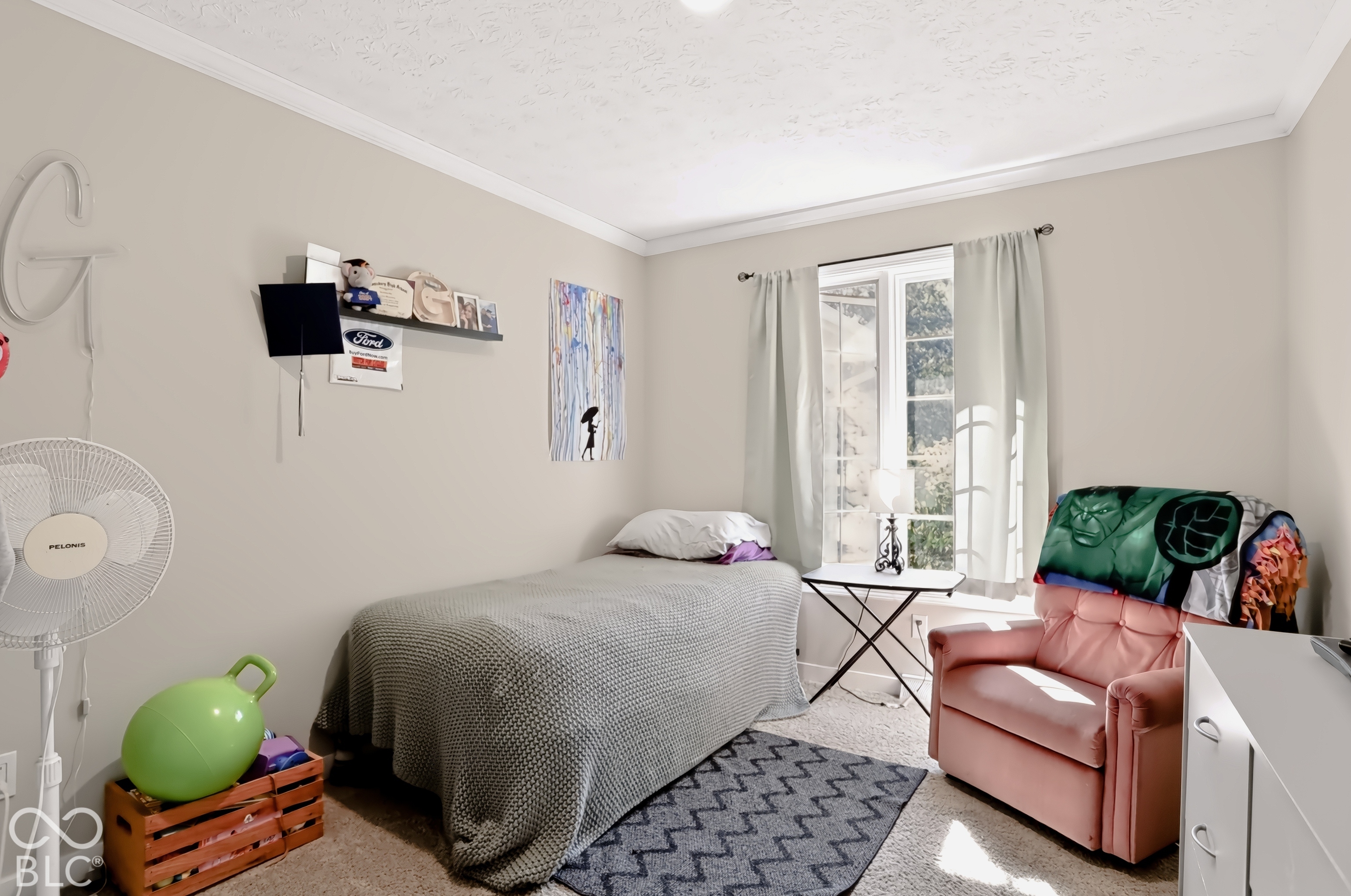 Recessed window with natural light, crown molding, and neutral wall paint