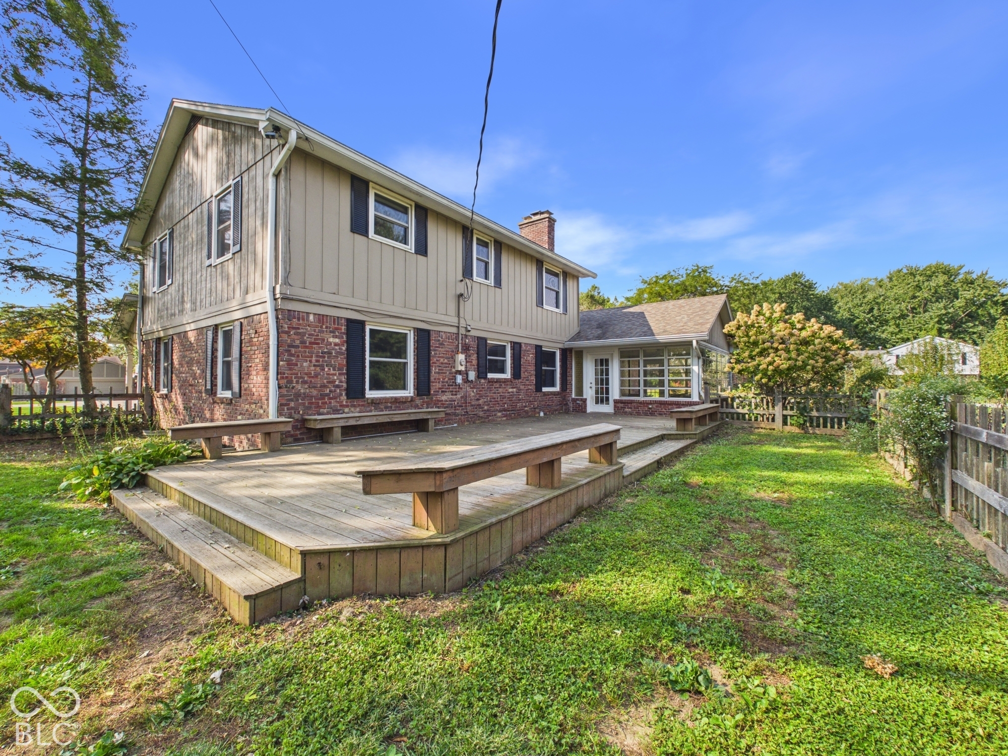 Multi-level wood deck with integrated benches