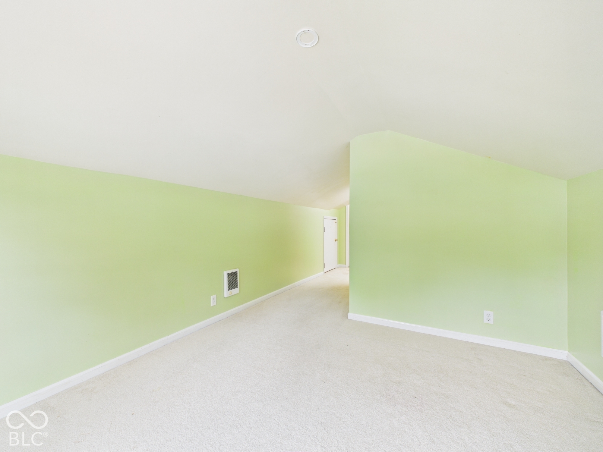 Carpeted flooring, sloped ceiling, and recessed lighting