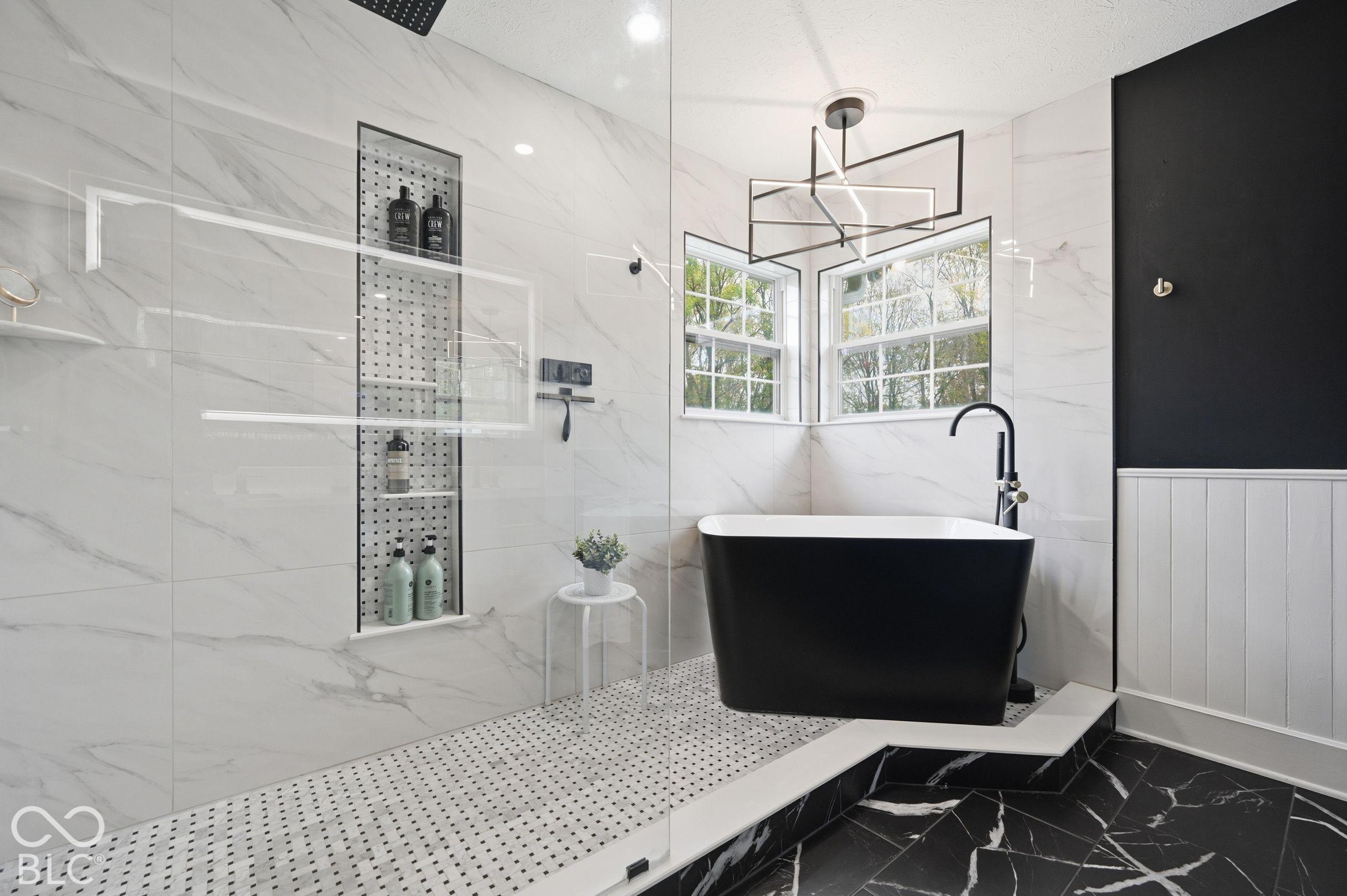 The Primary Bathroom Features A Japanese Soaker Tub & A Large Walk-In Shower With A Moen Digital Shower System, Rainfall Shower & Carrara Marble Floors & Shelf