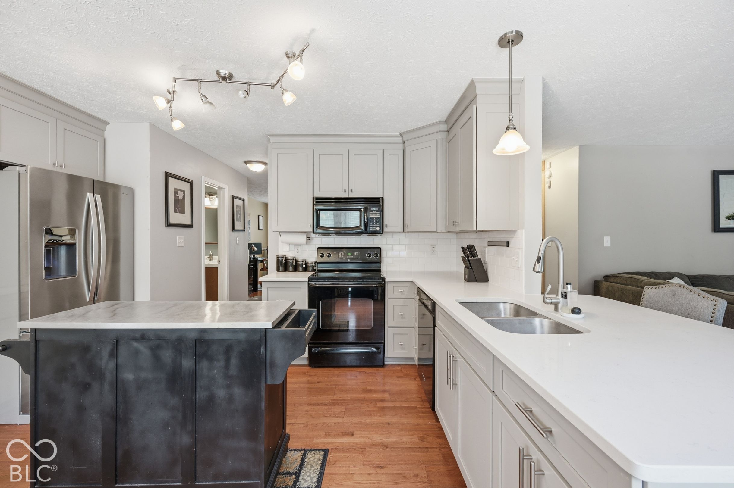 The Kitchen Features A Breakfast Bar