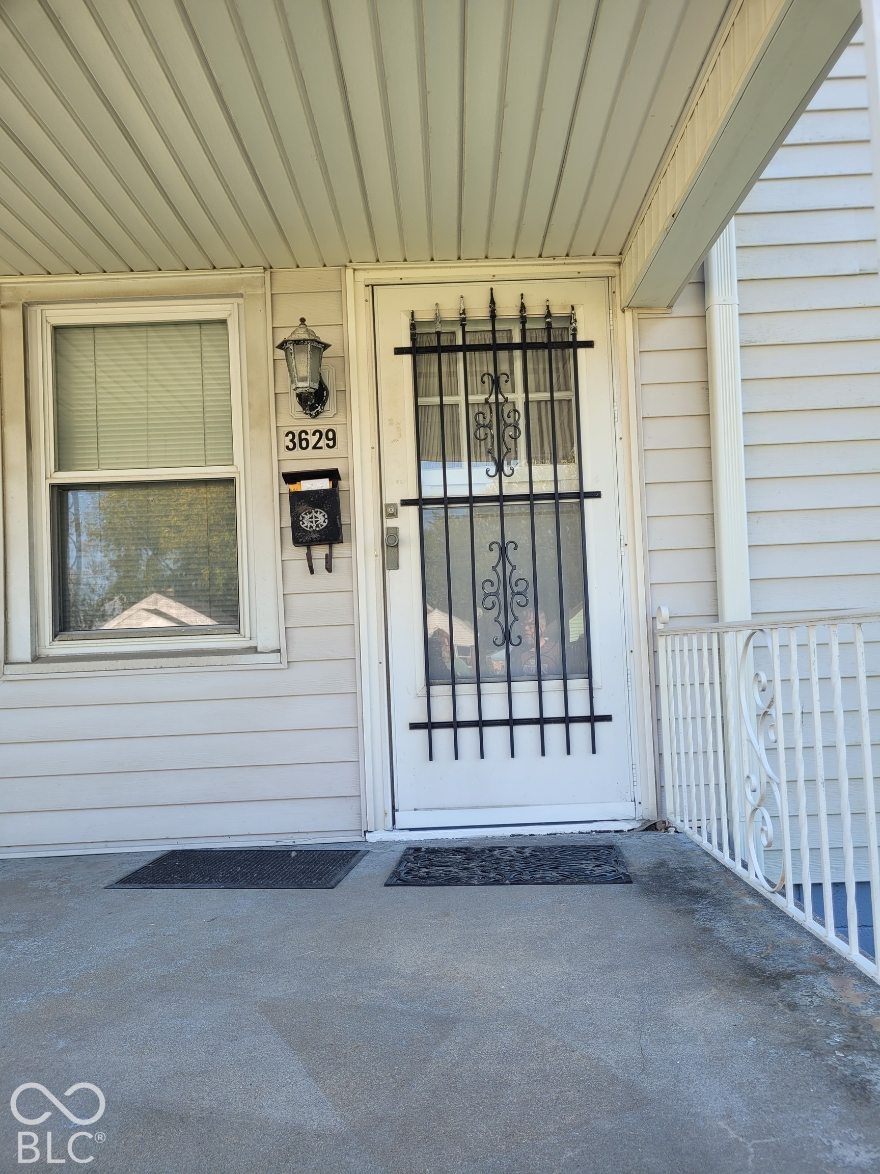detail of front door - - - roomy porch with decorative railings