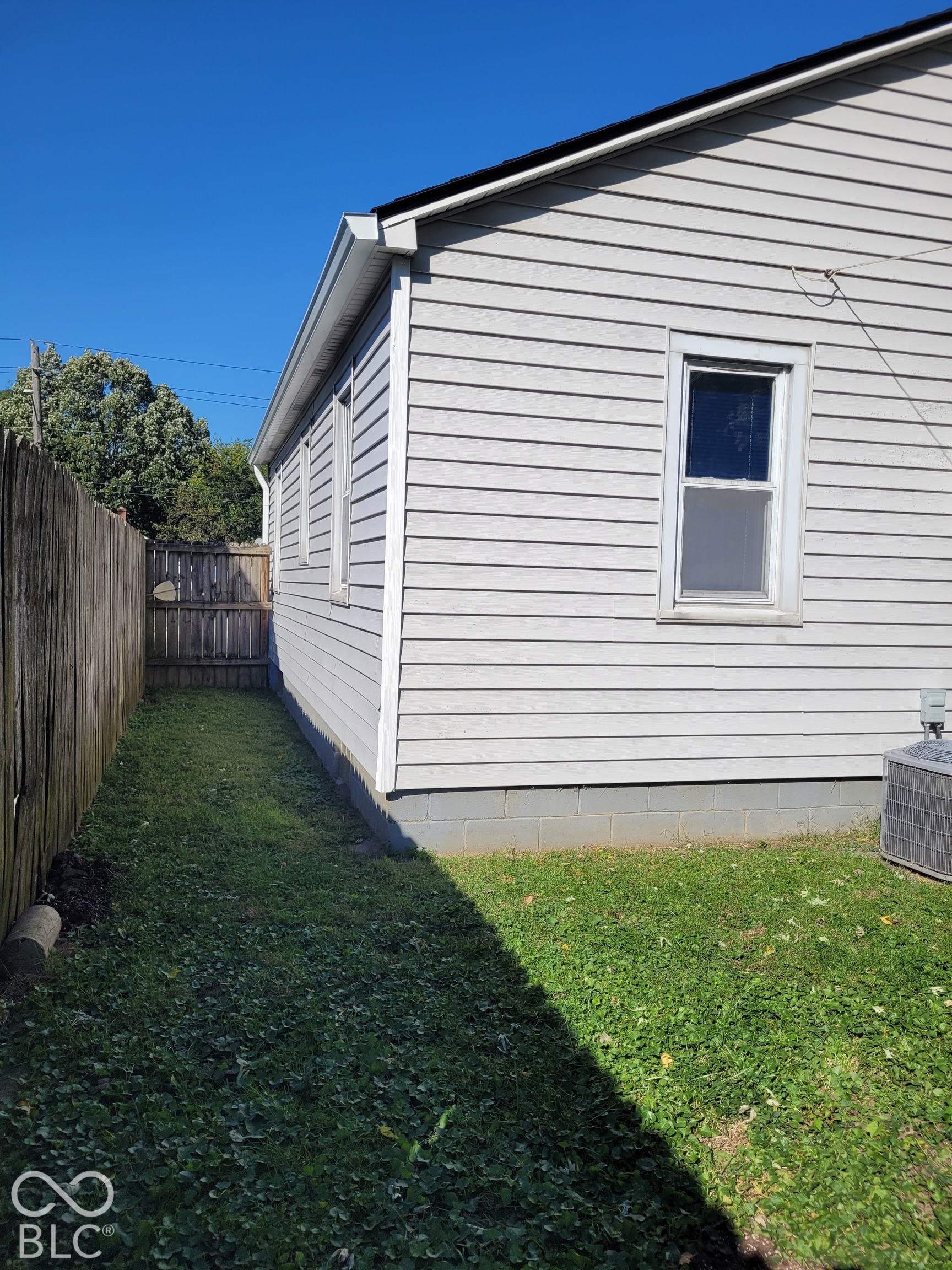 back yard - - side view showing fence and side of home